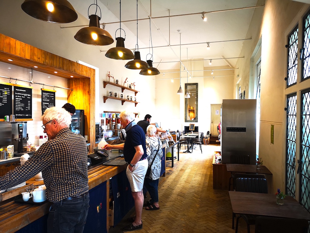 a large mirror, contemporary decor of inside orangery cafe